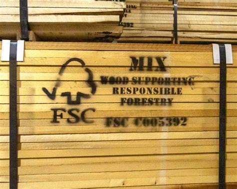 Stacked FSC-certified lumber in a warehouse, ready for responsible use in construction.